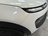 a close up of the front of a white car