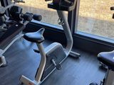 two exercise bikes and a stationary bike in the gym