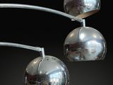 three chrome balls hanging from the ceiling of a room