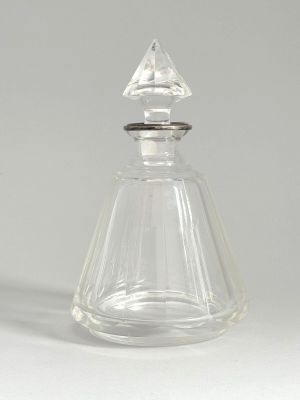 clear glass perfume bottle with a silver lid and a diamond shaped top