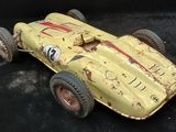a yellow toy race car with numbers on it