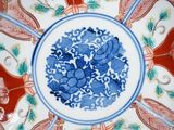 a blue and white plate with flowers and birds on it
