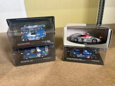 two model cars in the boxes on the table