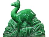 a green statue of a deer in the middle of a field