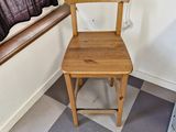 a wooden chair sitting next to a window in a room