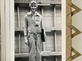 a black and white photo of a man standing in front of a building