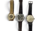 three different types of watches are shown on a white surface