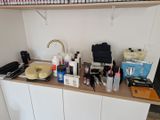 a counter with a lot of beauty products on top of it