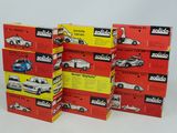 five boxes of different models of cars on a white surface