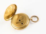 an image of a gold pocket watch on a white surface