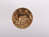 a close up of a gold coin with a horse on it