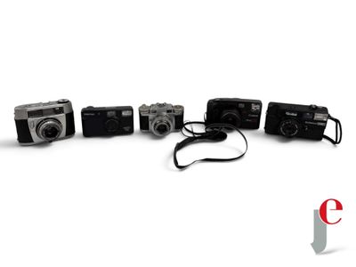 five cameras sitting next to each other on a white surface