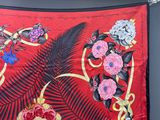 a red and black floral design on a red cloth