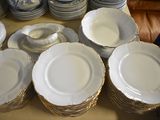 a lot of plates and bowls sitting on a table