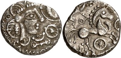 a silver coin with an image of a horse on it