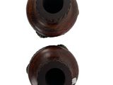 two wooden vases sitting next to each other on a white surface