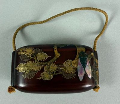 an image of a brown purse with a flower design on it