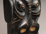 an image of a wooden sculpture of a man ' s face with teeth
