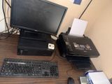 a desktop computer and a printer on a desk