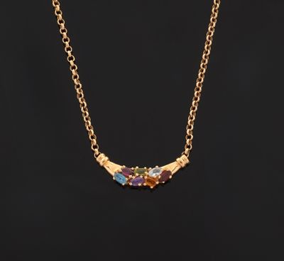 a gold necklace with multi colored stones on a black background