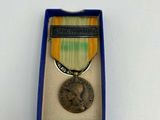 an image of a medal in a blue box on a white surface