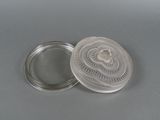a small silver container with a lid on a table