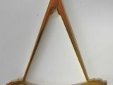 an image of a brass masonic symbol hanging on a white wall