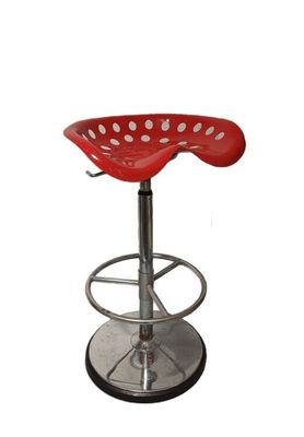 Le tabouret rouge est doté d'un piètement métallique et d'un repose-pieds métallique.