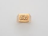 a gold signet ring with the letter fy on it