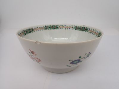 un bol blanc orné de motifs verts et rouges