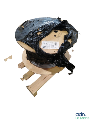 a picture of a spool wrapped in plastic on a pallet