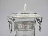 a silver vase with a chain around it on a table