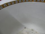 a white bowl with a yellow border on it
