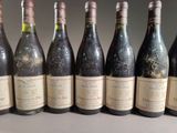 six bottles of wine are lined up in a row on a table