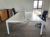 a white desk with a computer on it in an office