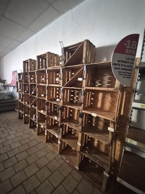 many wooden crates stacked on top of each other in a room