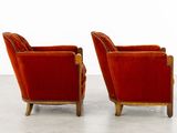 pair of red velvet club chairs in the manner of person
