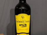 a bottle of wine sitting on a wooden tray