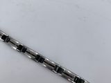 a black and white bracelet that is laying on a table