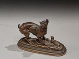 bronze statue of a dog and a cat on a wooden base