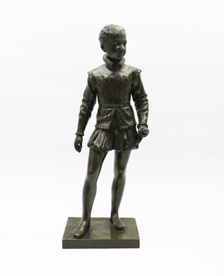 bronze statue of a boy in a skirt standing on a base