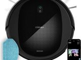 a close up of a robot vacuum cleaner with a phone next to it
