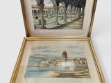 two framed paintings of a view of a city with a fountain