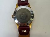 an image of a close up of a wrist watch on a white surface