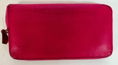 a pink purse with a zipper on the inside