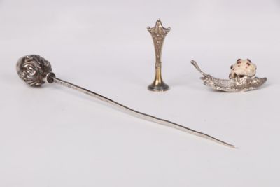 a silver spoon with a spoon rest and a spoon with a spoon in it
