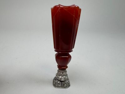 an image of a red glass vase with a silver base