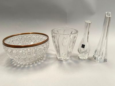 several pieces of glass and a bowl on a white surface