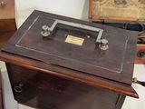 an old sewing machine sitting on a table next to a box