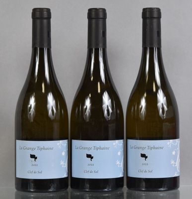 three bottles of wine sitting on top of a table next to each other